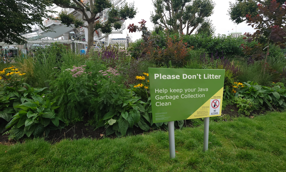 A do not litter sign in front of some foliage. It is a play on garbage collection in Java.